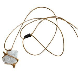 Wrapped raw clear quartz necklace. On a tan string.